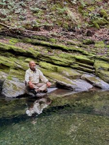 Celes beside a creek in the Wabanaki Forest. Photo by Ken Shorley.